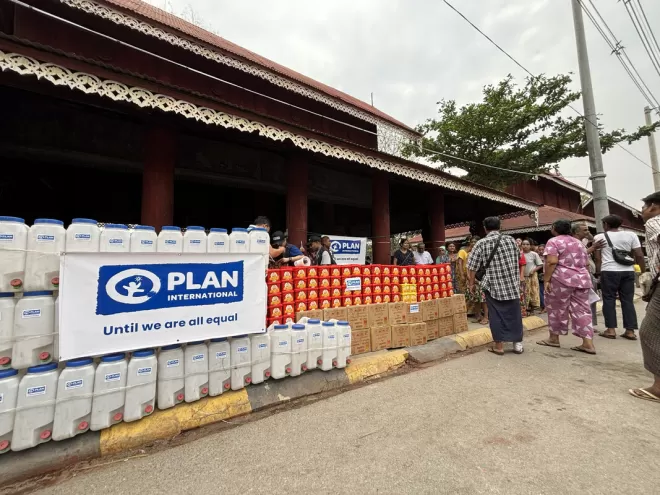 Aid in Myanmar stacked up ready for people to receive from Plan International