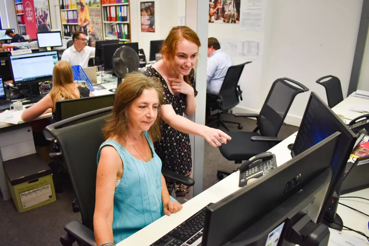DEC staff look at a computer