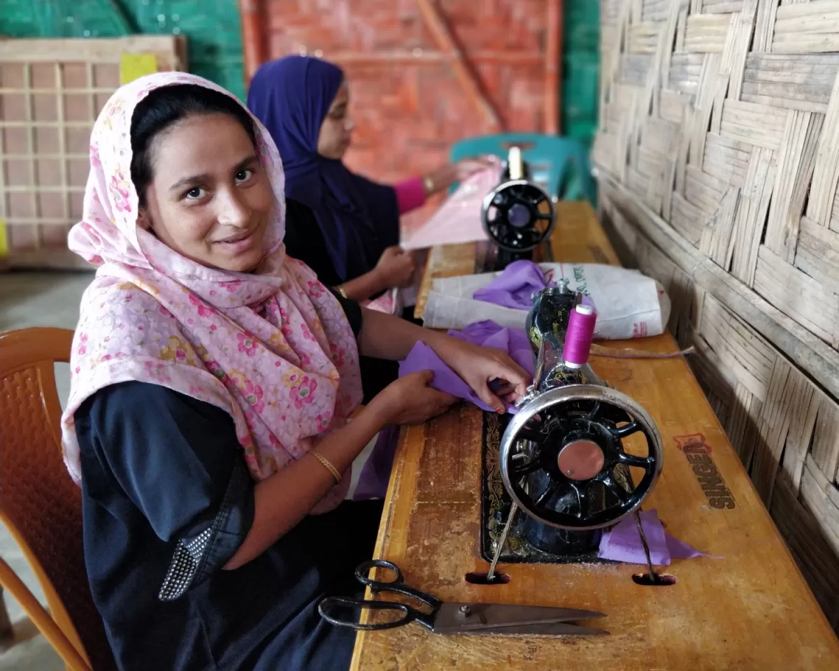 Noor Hasina uses a sewing machine
