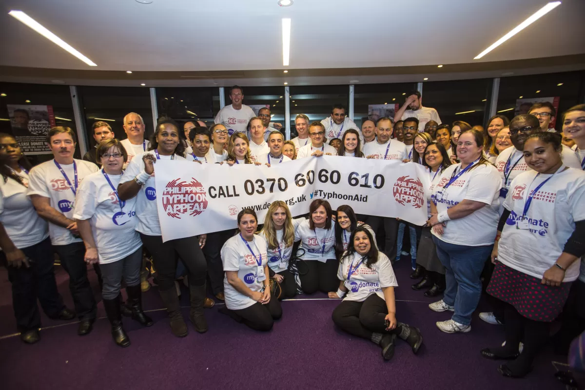 A group of BT staff hold a banner during the Philippines Typhoon telethon