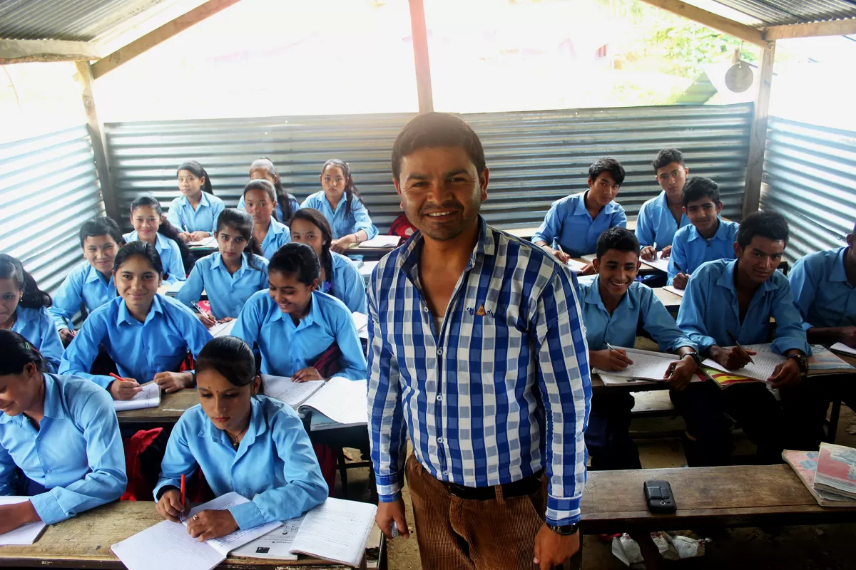 A teacher and pupils in a temporary classroom