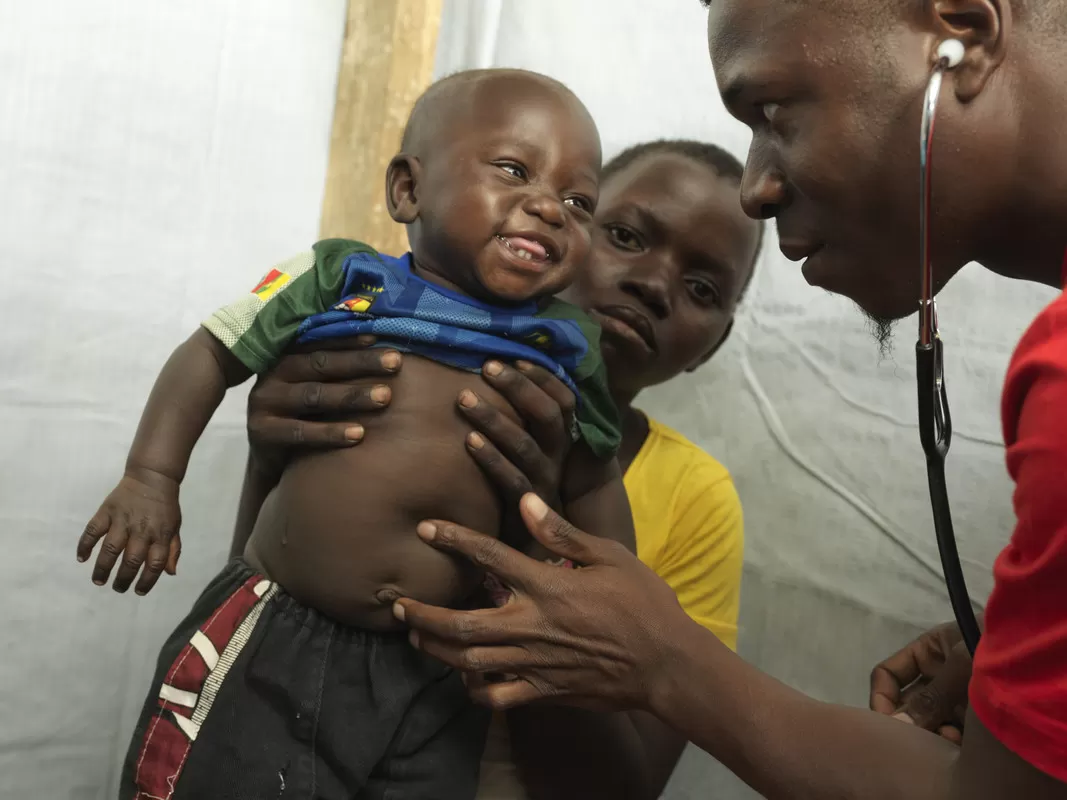 A child is examined at a mobile health clinic