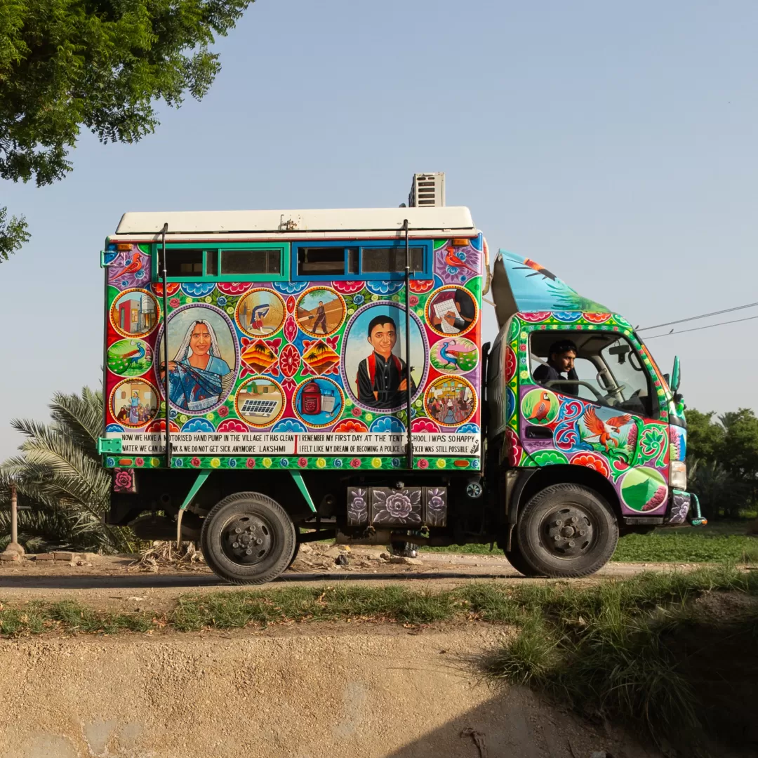 Painted truck drives through village in Sindh, Pakistan