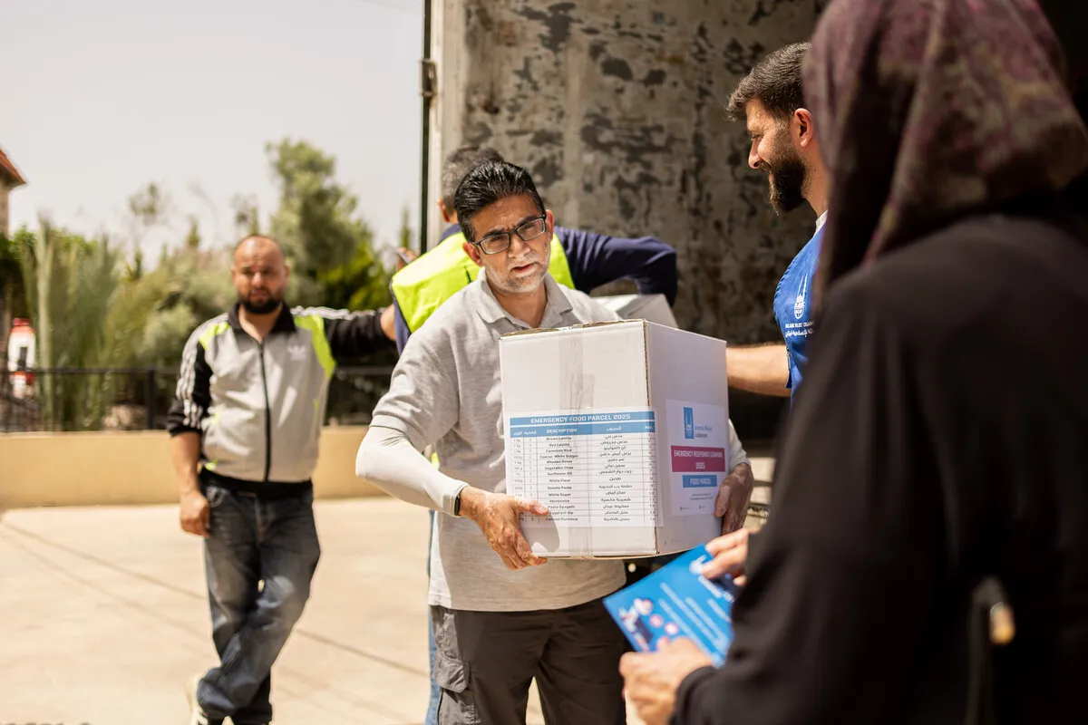 Man carries aid box in Lebanon