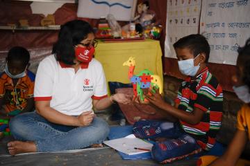 Susmita (left) interacts with students during a class at a Multi Activity Centre in West Bengal, India. 